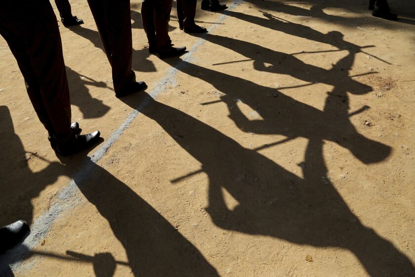 FILE – In this Oct. 21, 2018, file photo, members of the Rashtriya Swayamsevak Sangh (RSS) or National Volunteer Organization cast shadows in Bangalore, India. Internal company documents from the former Facebook product manager-turned-whistleblower Frances Haugen show that in some of the world's most volatile regions, terrorist content and hate speech proliferate because the company remains short on moderators who speak local languages and understand cultural contexts. (AP Photo/Aijaz Rahi, File)