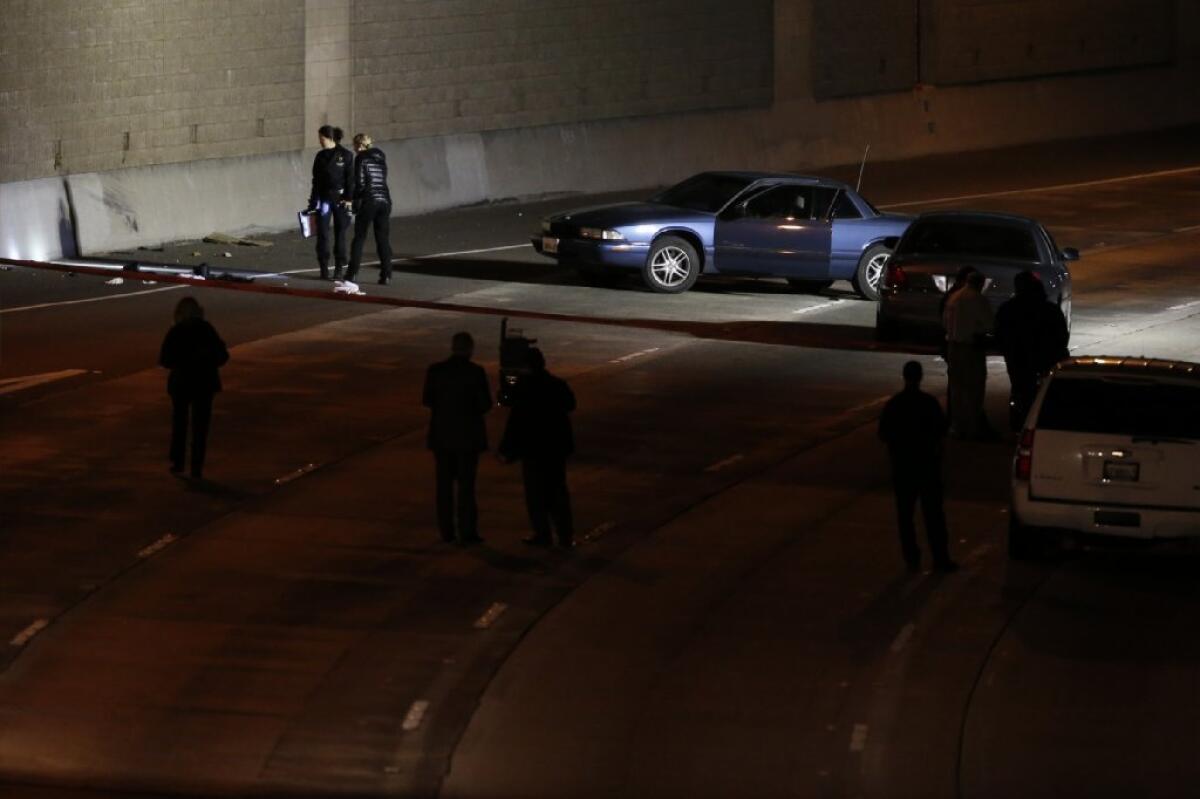 Detectives probe the scene of the January shootout on the 5 Freeway that led to Artyom Gasparyan's capture.