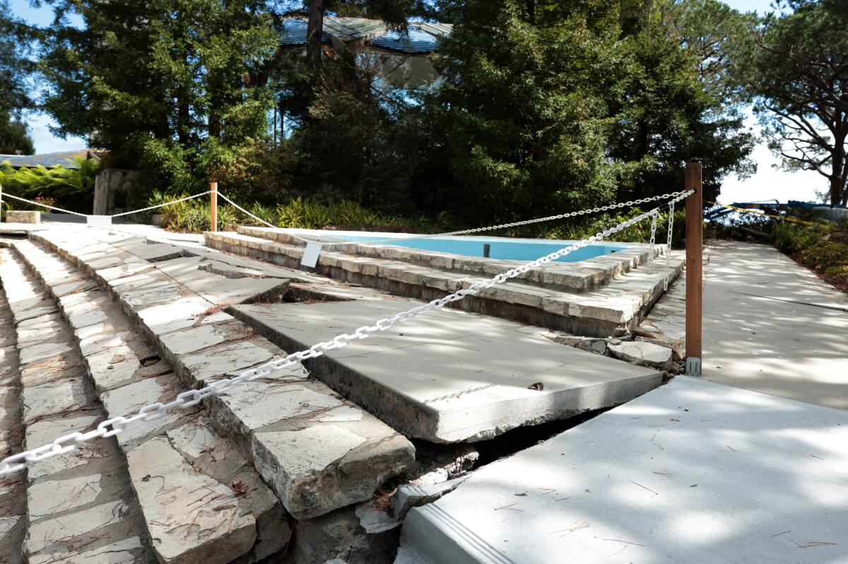 Concrete steps buckling because of land movement are roped off at Wayfarers Chapel.