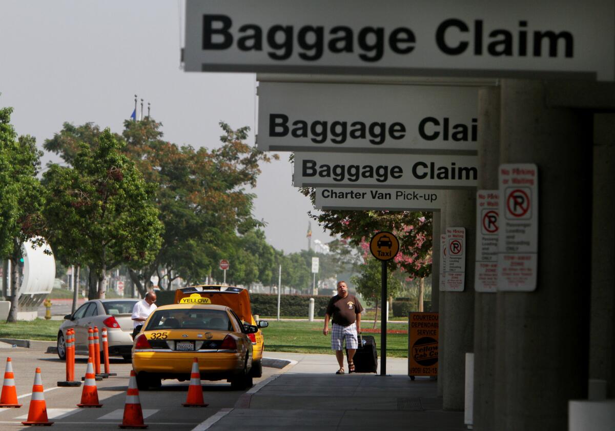 A traveler walks into Terminal 2 at L.A./Ontario International Airport to catch a flight. The airport has lost almost 40% of its traffic since 2007.