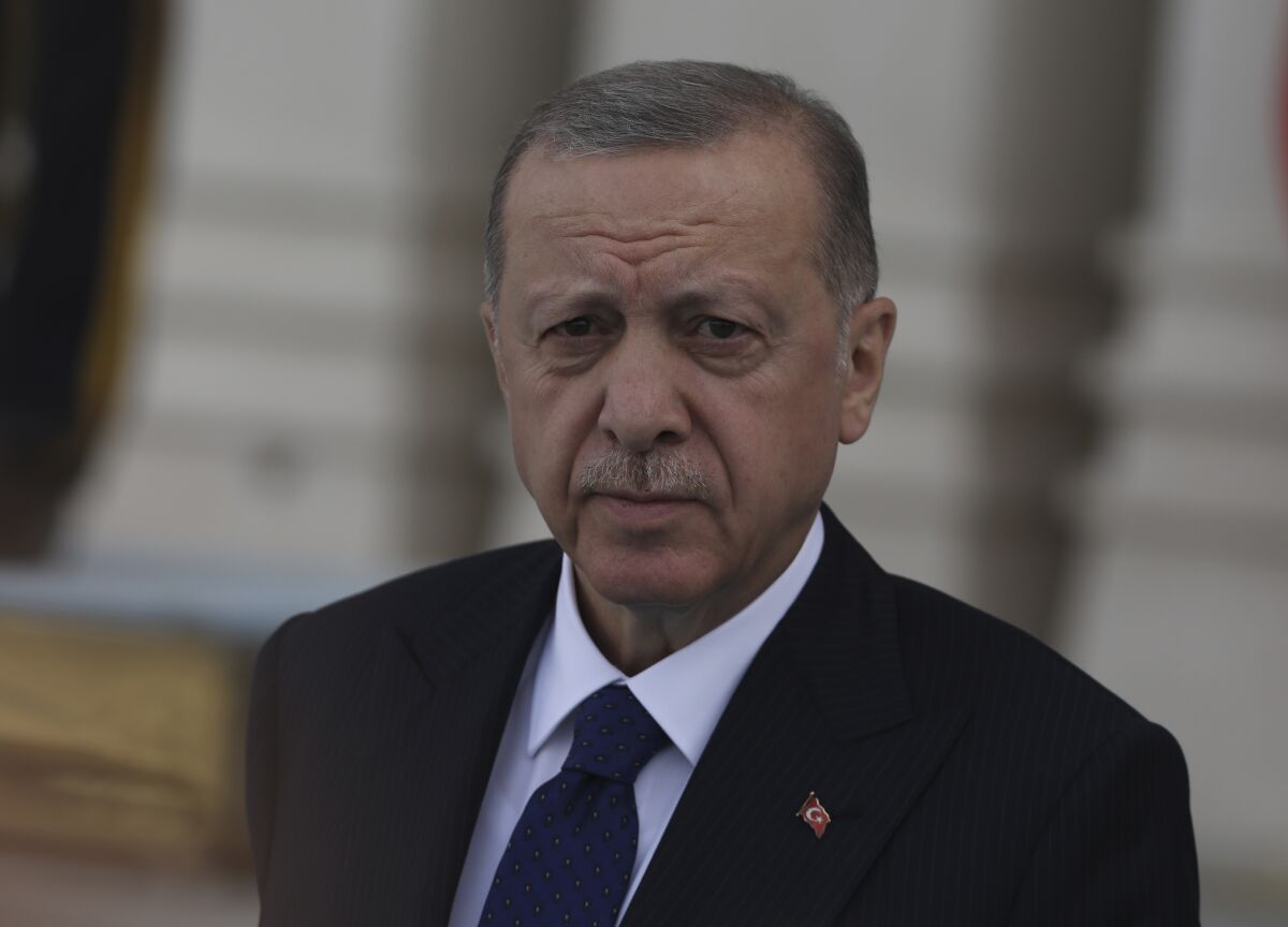 Turkish President Recep Tayyip Erdogan arrives for an official welcome ceremony, in Ankara, Turkey, Wednesday, June 8, 2022. Erdogan on Thursday warned Greece to demilitarize islands in the Aegean, saying he was "not joking" with such comments. Turkey says Greece has been building a military presence on Aegean in violation of treaties that guarantee the unarmed statues of the islands. (AP Photo/Burhan Ozbilici)