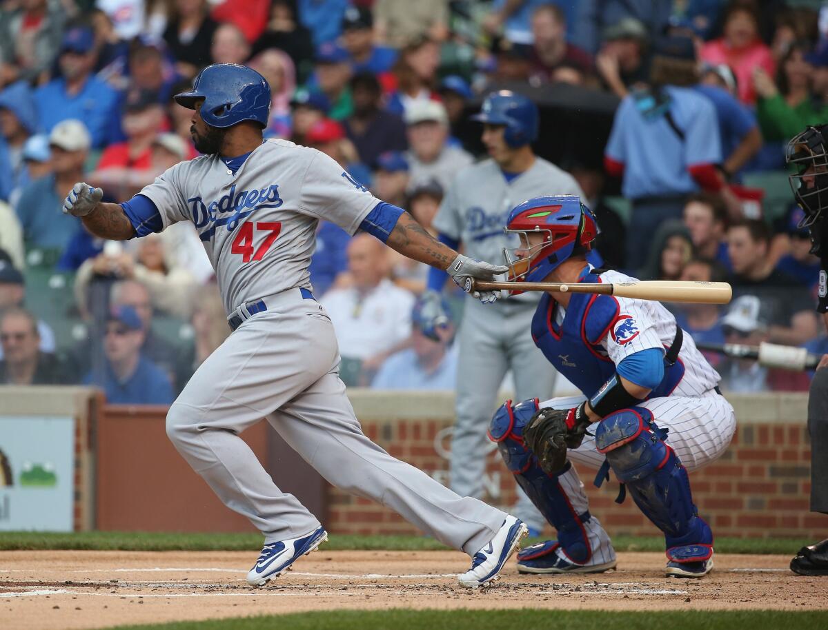 Howie Kendrick hits a two-run double in the first inning of the Dodgers' 4-0 victory over the Chicago Cubs on Thursday at Wrigley Field.