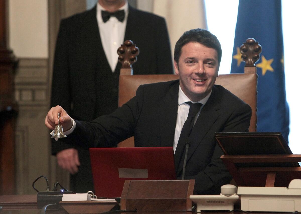 Italy's new Prime Minister Matteo Renzi rings the bell to open his first Cabinet meeting on Saturday in Rome. Renzi is the country's youngest ever prime minister.