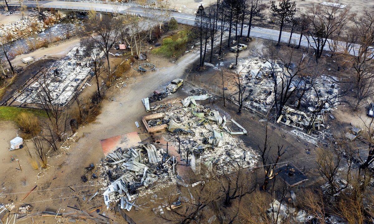 In this photo taken by a drone, homes destroyed by the Mountain View Fire line a street in the Walker