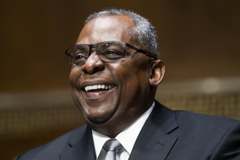 Secretary of Defense nominee Lloyd Austin, a recently retired Army general, smiles during his conformation hearing before the Senate Armed Services Committee on Capitol Hill, Tuesday, Jan. 19, 2021, in Washington. (Jim Lo Scalzo/Pool via AP)