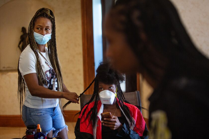 LOS ANGELES, CA - MAY 16: Unable to open their Mid-City Salon, hair stylists Tia Rose of North Hollywood and Christina Rose of West Covina styles a clients hair in an AirBnb in order to earn a living during the coronavirus pandemic on Saturday, May 16, 2020 in Los Angeles, CA. Salons across Los Angeles have been classified as nonessential businesses forcing some hairstylist to take their business underground. (Jason Armond / Los Angeles Times)