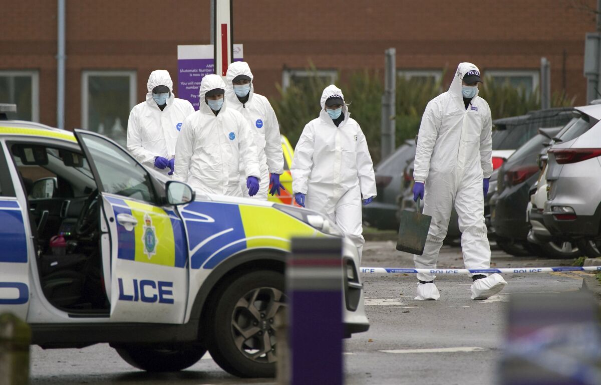 Forensic police officers walk outside Liverpool Women's Hospital after an explosion on Sunday killed one person and injured another, in Liverool, England, Tuesday, Nov. 16, 2021. British police have released four men arrested under terrorism laws by detectives investigating a homemade bomb explosion in a Liverpool taxi, as they work to understand the motives of the suspected bomber, who died in the blast. (Peter Byrne/PA via AP)