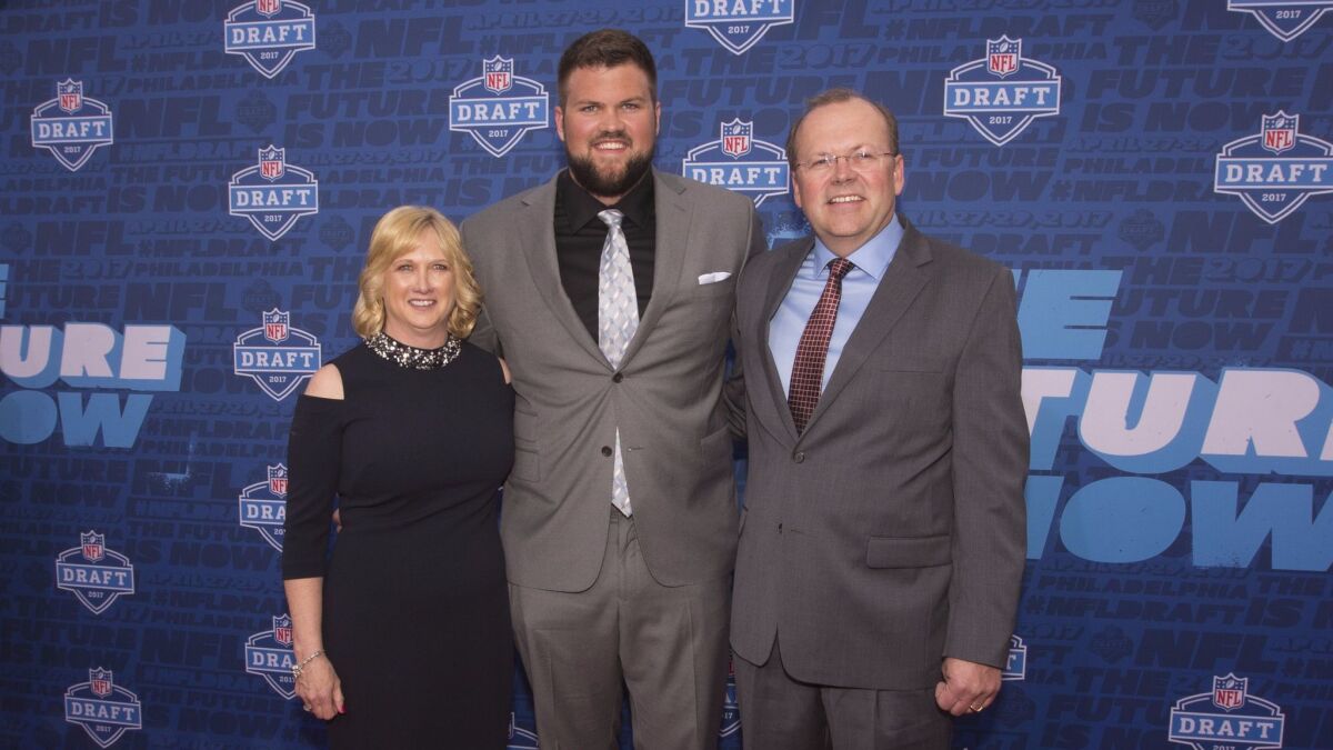 Ryan Ramczyk poses for a picture with his mother, Lori, and father, Randy, on the red carpet prior to the start of the NFL Draft.