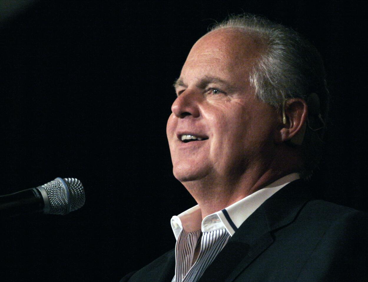 Rush Limbaugh speaks into a microphone.