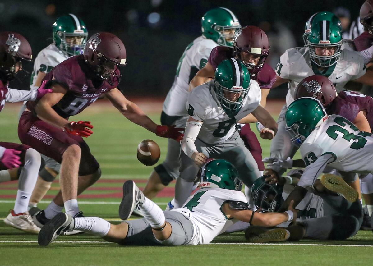 Laguna Beach's Ryner Swanson (87) eyes a fumble bouncing out of the scrum against Granada Hills on Saturday.