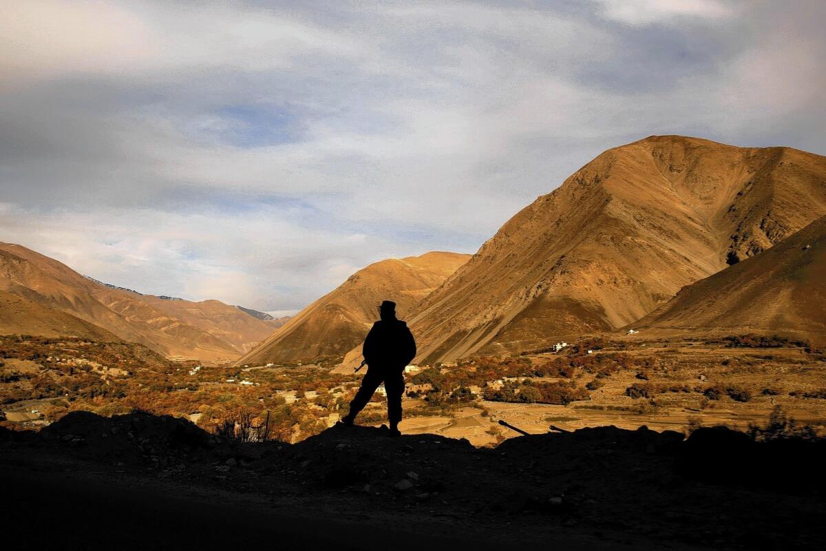 Afghan army member looks over Afghanistan horizon