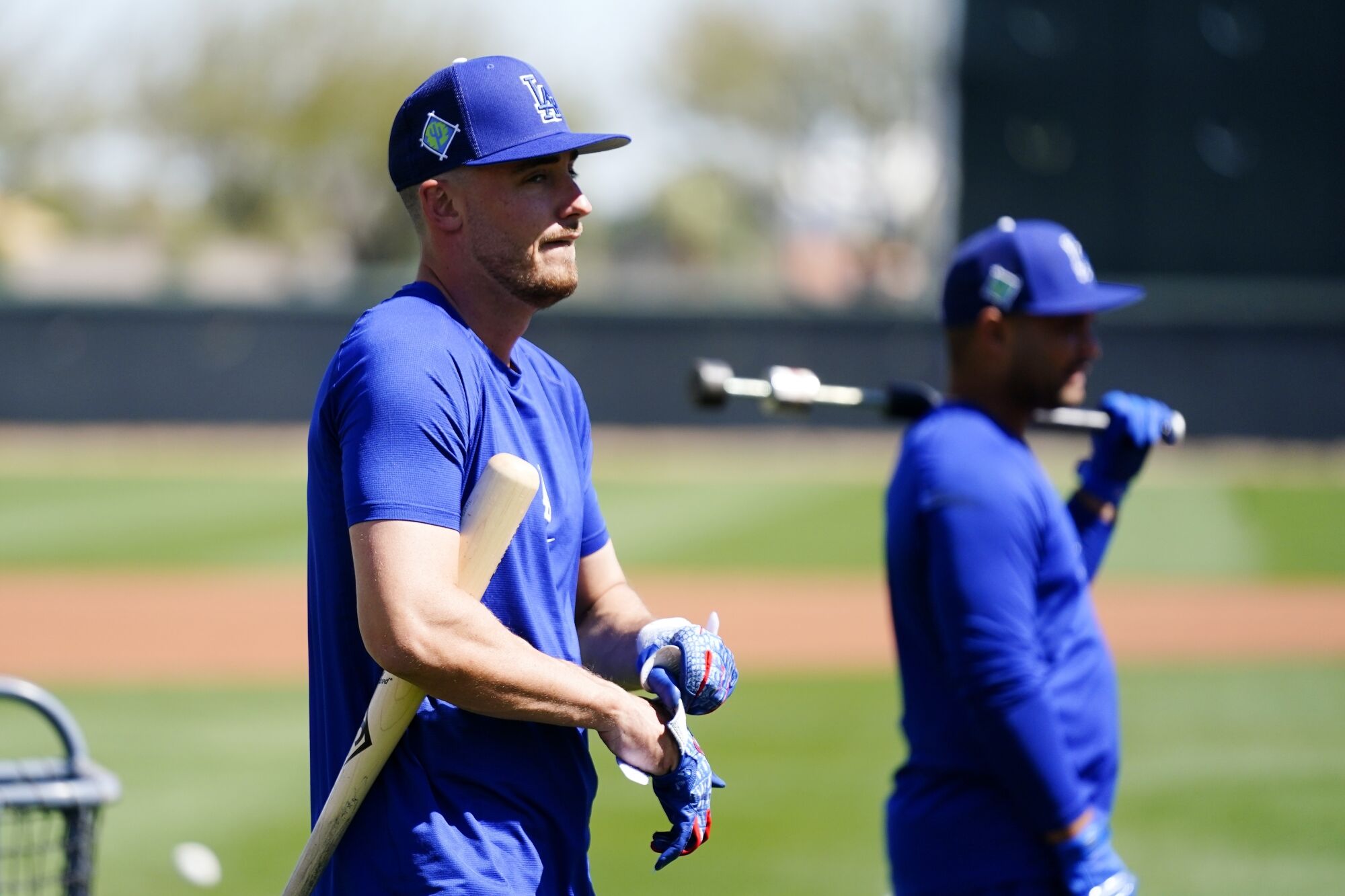 The Dodgers' Cody Bellinger, left, and Tomás Telis wait their turn for batting practice March 13 at spring training.
