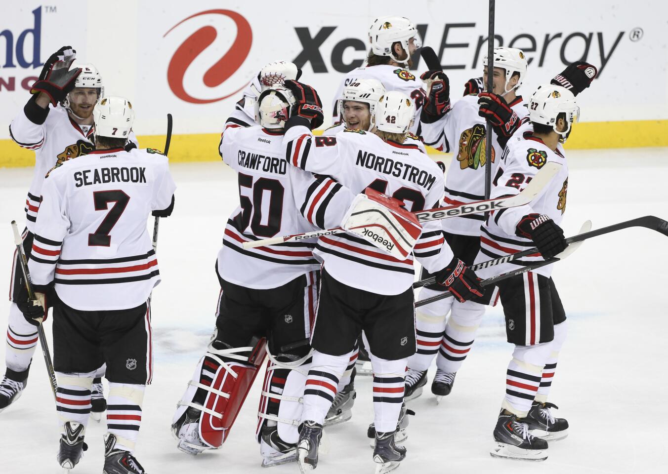 Blackhawks players celebrate their series-clinching win in overtime.