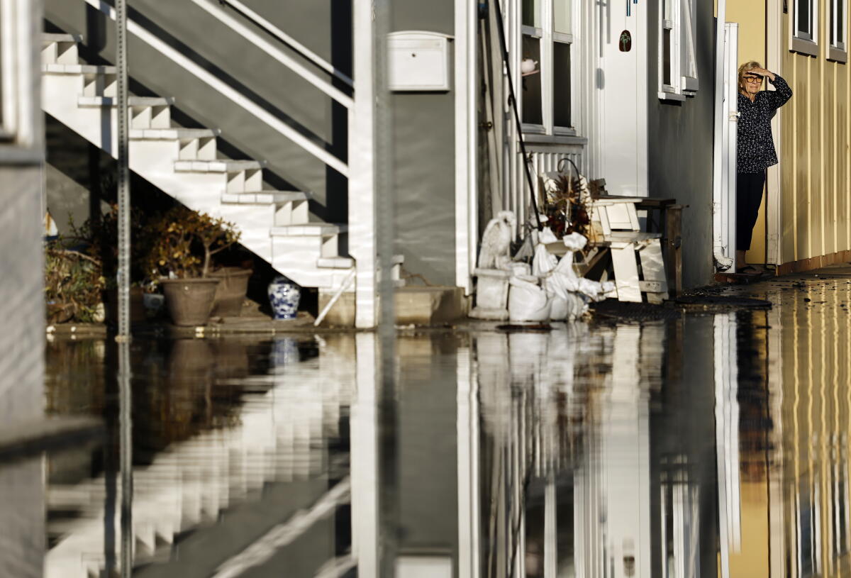 A personification opinionated adjacent a flooded street