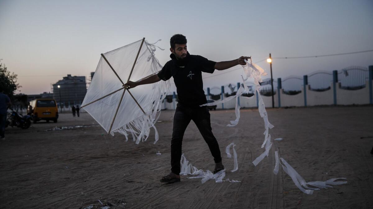 A Palestinian readies a kite that will carry a torch in the Bureij refugee camp near Deir al Bala in the Gaza Strip.