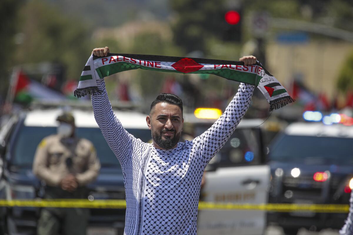 A supporter of Palestine demonstrates outside the federal building in Westwood on May 15, 2021. 