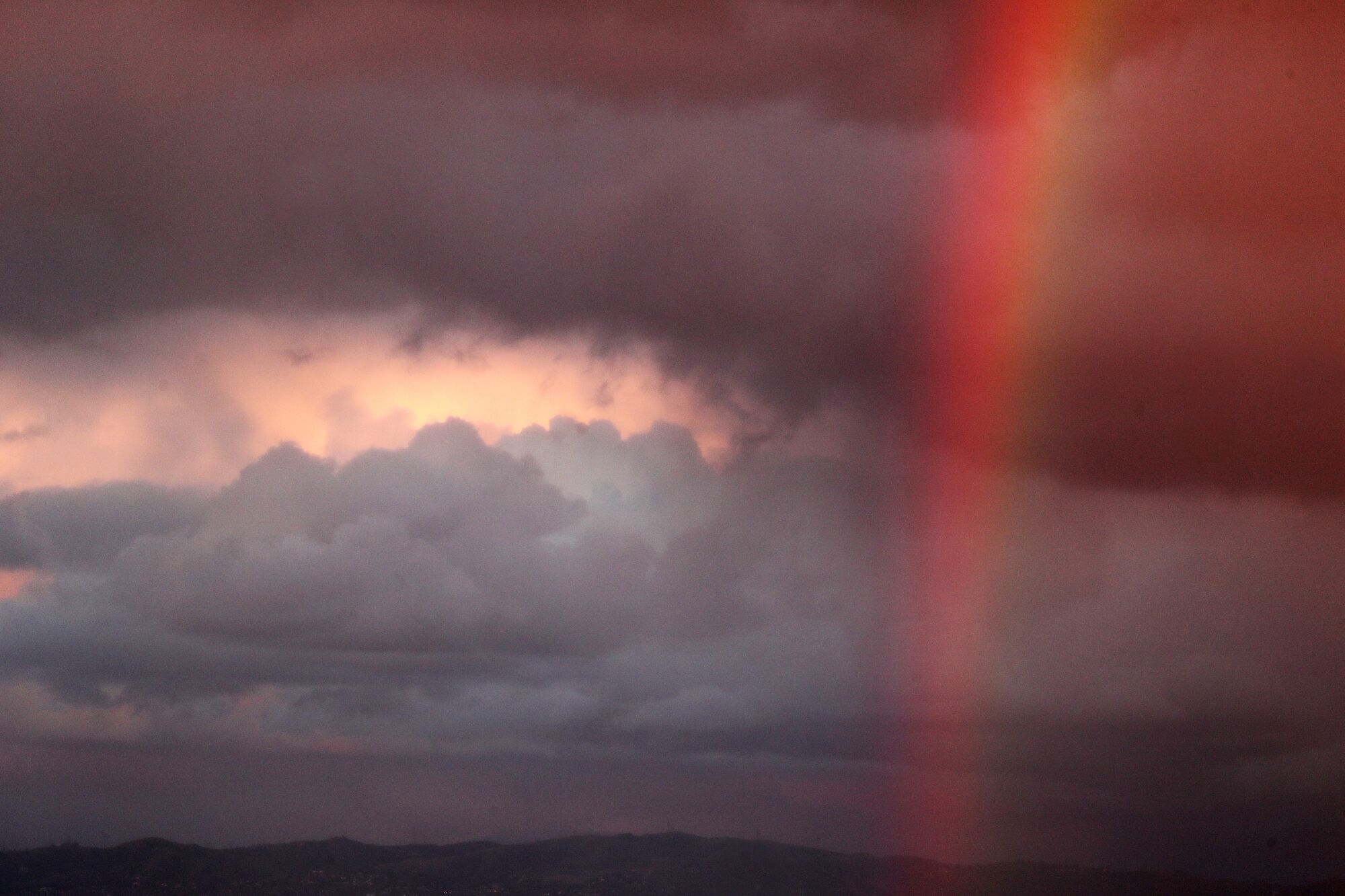 LA rainbow forms as a storm front drops precipitation across the Los Angeles Basin.