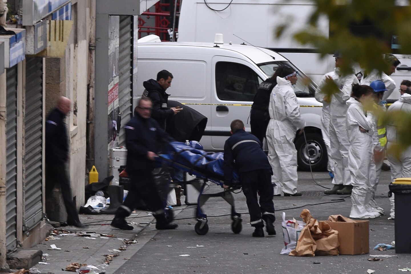 A body is removed from the apartment raided by French Police special forces earlier in the northern Paris suburb of Saint-Denis, searching those behind the attacks that claimed 129 lives in the French capital five days ago.
