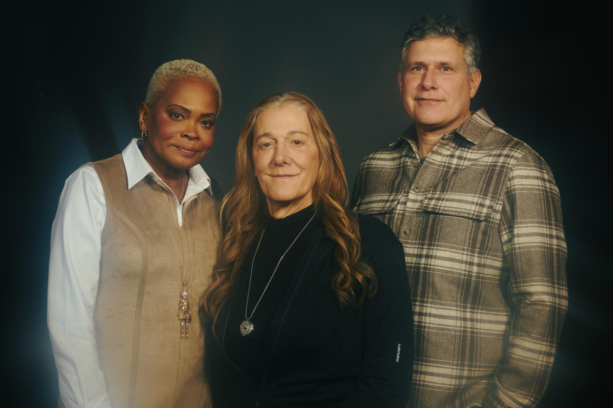 Three people pose for a portrait.