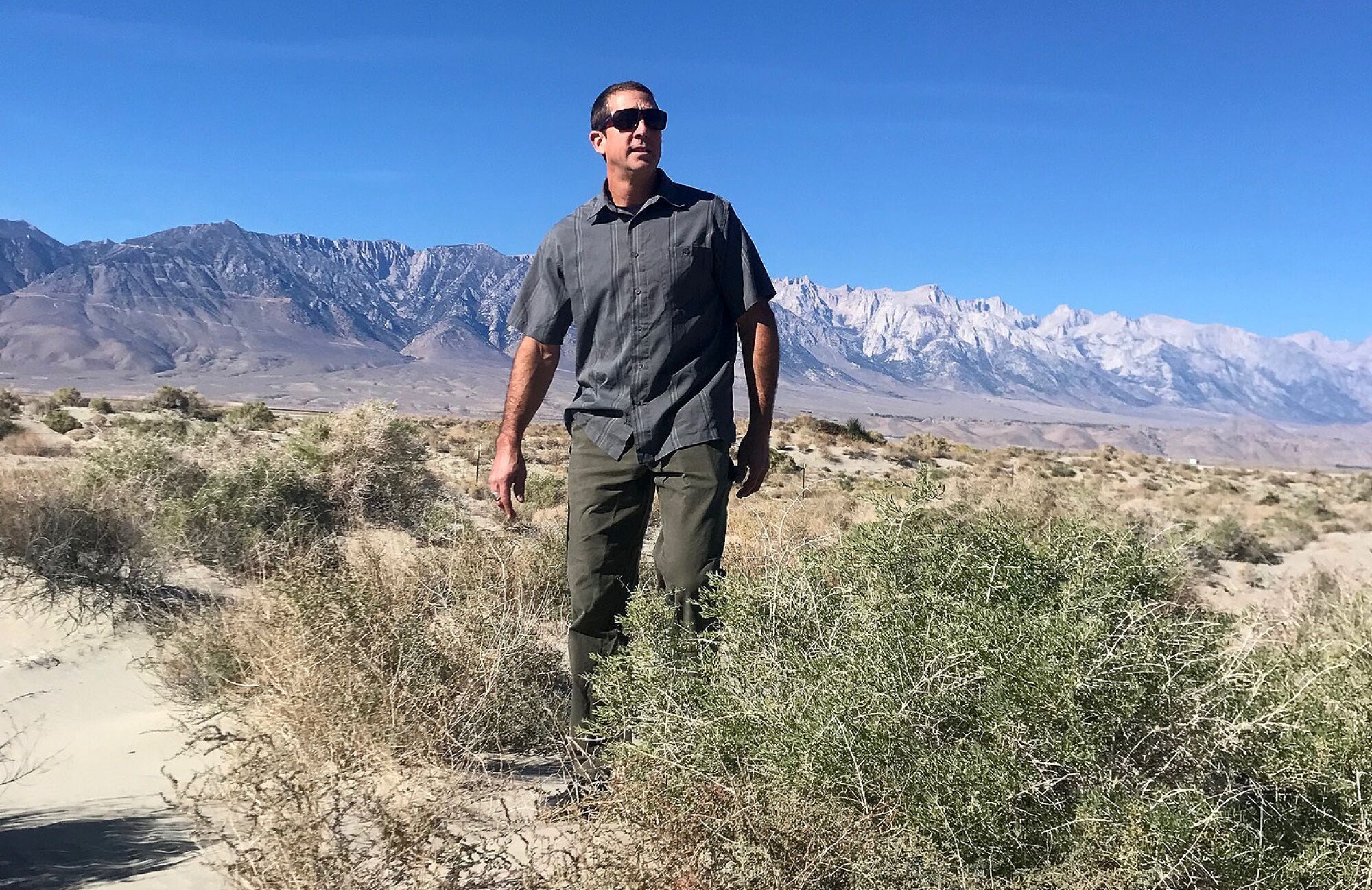 Phillip Kiddoo of the Great Basin Unified Air Pollution Control District walks along the northern rim of dry Lake Owens.