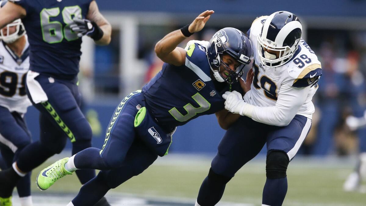 Seattle Seahawks quarterback Russell Wilson (3) is sacked by Rams defensive tackle Aaron Donald in the second quarter on Dec. 17, 2017.