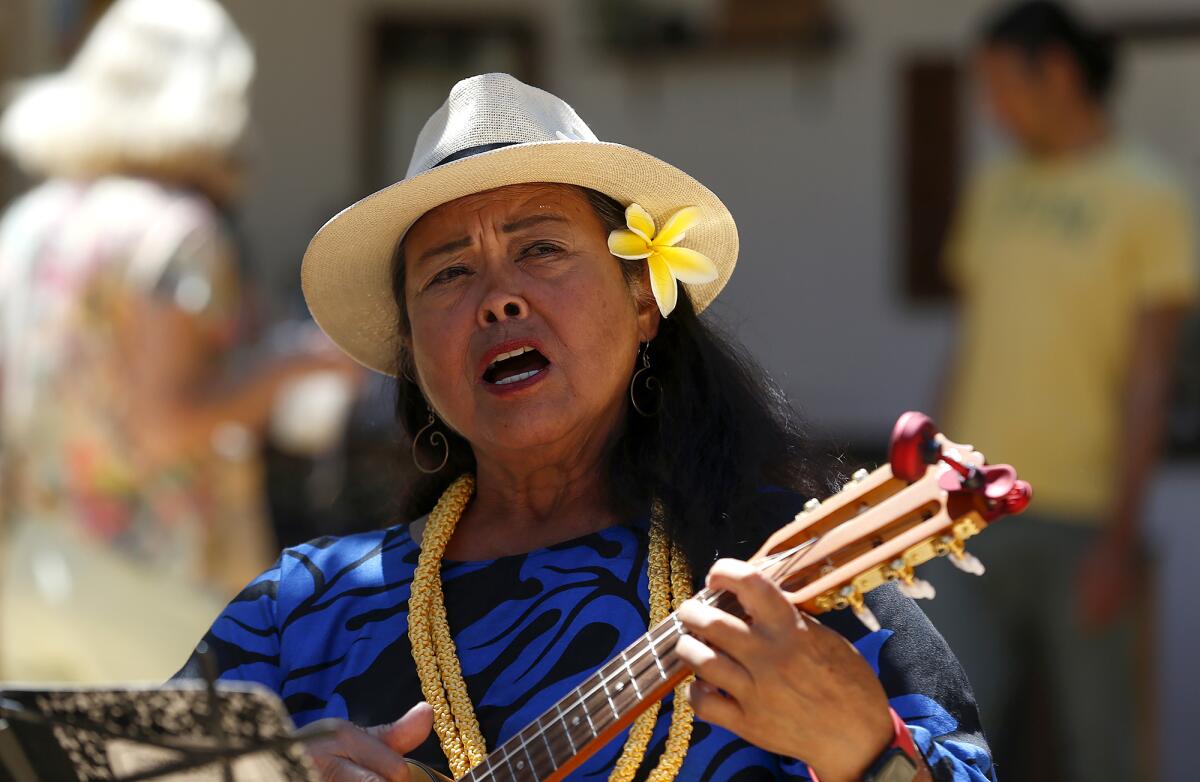 Joice Alapag sings a traditional Hawaiian song at the Spirit of Aloha fundraiser.