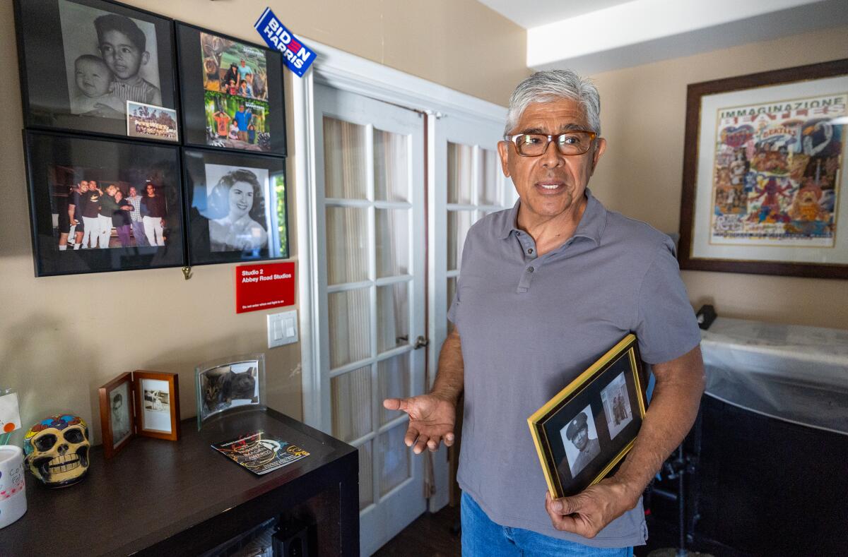 Larry Herrera-Cabrera, shown holding a photo of his Uncle Henry, killed in combat during World War II.