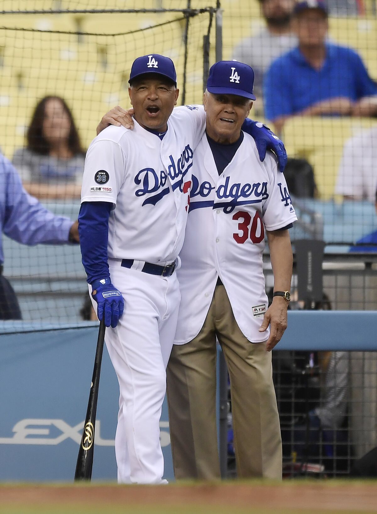 Dodgers manager Dave Roberts, left, stands with Maury Wills during an alumni game June 1, 2019, at Dodger Stadium.