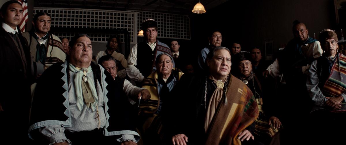A gathering of men in tribal clothing in "Killers of the Flower Moon."