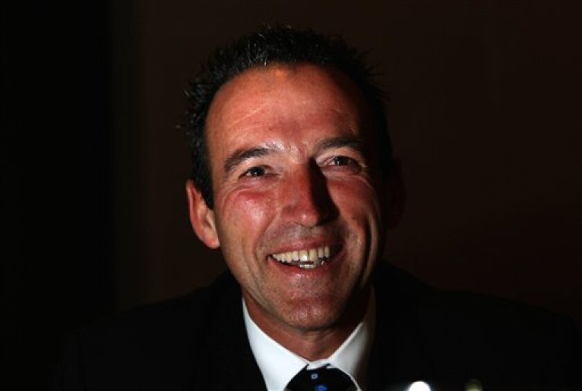In this photo taken Nov. 18, 2005, Graeme Hart smiles in Auckland, New Zealand. The reclusive New Zealand billionaire buying the U.S. maker of Hefty brand trash bags to create the world's second-biggest packaging business started out as a tow truck driver and bounced back from the brink of bankruptcy more than a decade ago to become his country's richest person. After dropping out of high school at age 16, Graeme Hart now has a fortune estimated at $4 billion by New Zealand's "National Business Review" rich list and holds spot No. 144 on Forbes magazine's list of the world's wealthiest people. (AP Photo/New Zealand Herald, Martin Sykes)
