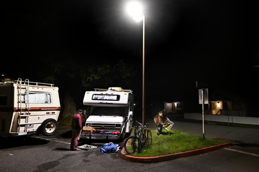 Arcata, California November 17, 2023-Students Brad Butterfield and Maddy Montiel prepare to move their campers off the Cal Poly Humboldt campus. The university recently issued an eviction notice for students who sleep in their vehicles. (Wally Skalij/Los Angeles Times)