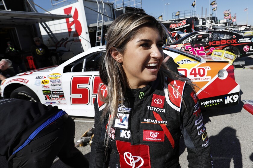 Driver Hailie Deegan greets fans after practicing for an ARCA Series auto race at Kansas Speedway last year in Kansas City, Kan. Deegan has moved from Toyota to Ford in a driver development deal intended to fast-track the rising star into one of NASCAR’s national series over the next few seasons.