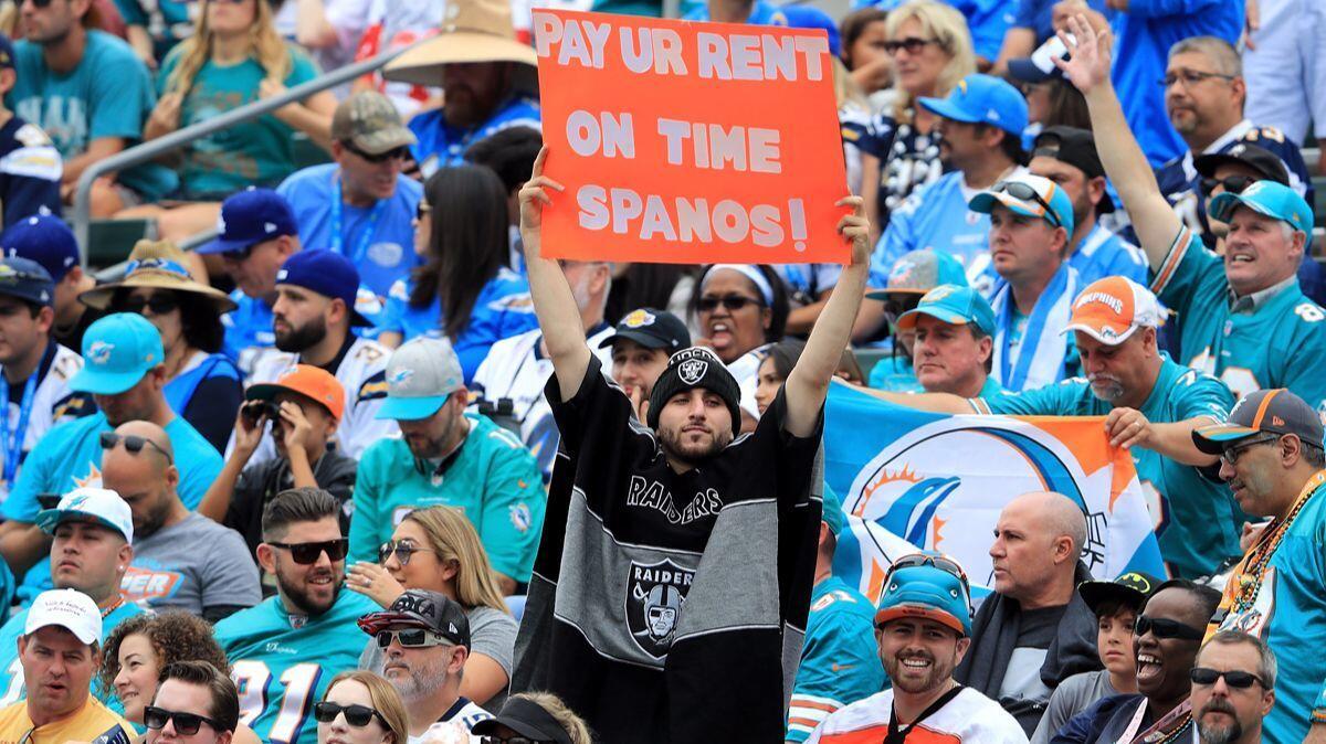 A fan holds a sign during the game between the Chargers and the Miami Dolphins at the StubHub Center on Sunday.