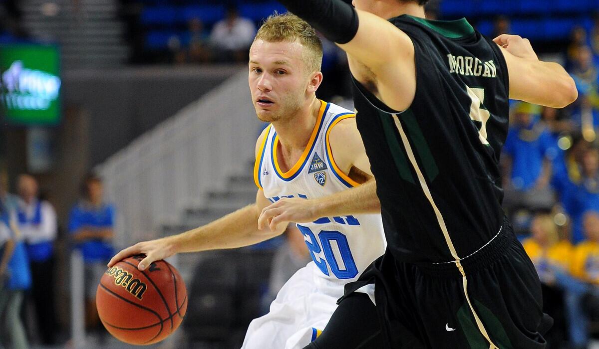 UCLA's Bryce Alford, left, drives on Cal Poly's Reese Morgan in the second half of a game Sunday.