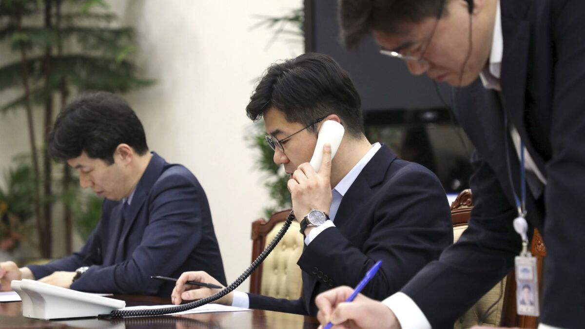 An official tests the hotline at the presidential Blue House in Seoul on Friday.