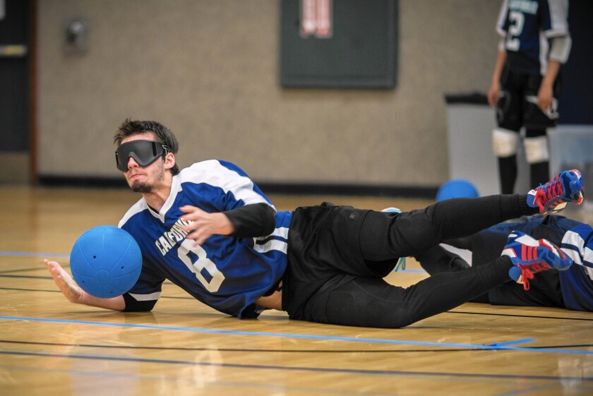 UC Berkeley freshman William Slason stops a ball during goalball practice at a gym on the UC campus. Participants may be sight impaired or fully sighted, but all wear eye masks during competition.