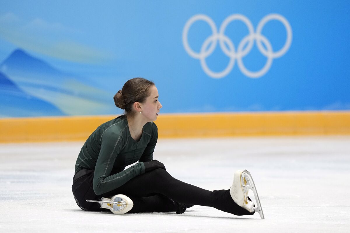 Kamila Valieva, of the Russian Olympic Committee, sits on the ice after falling during a training session at the 2022 Winter Olympics, Sunday, Feb. 13, 2022, in Beijing. (AP Photo/David J. Phillip)