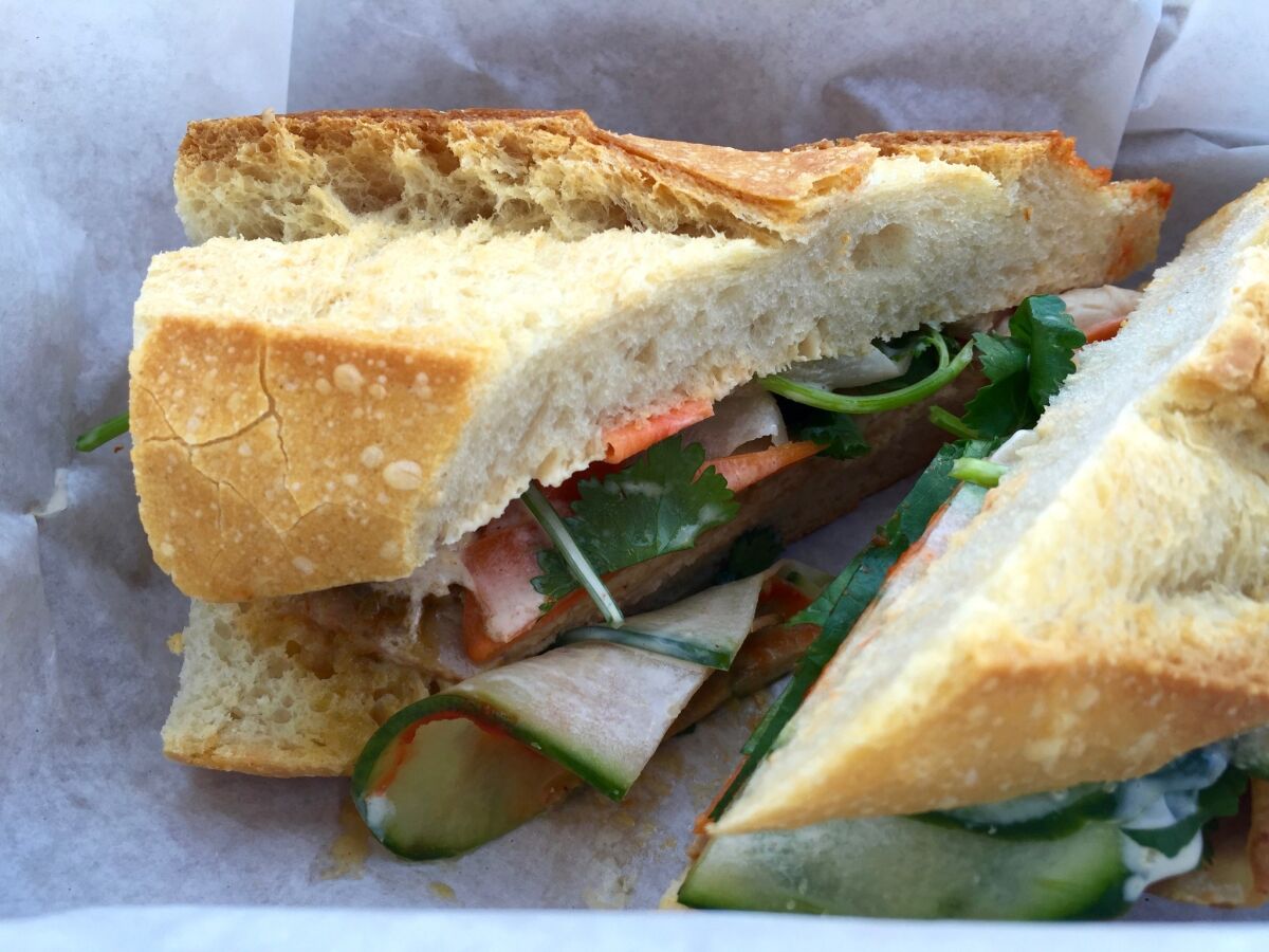 Take time to support your favorite local restaurants by ordering takeout or buying gift cards. The Steve Julian sandwich, shown here, is Wax Paper’s take on the banh mi. The sandwich is stuffed with roasted pork loin, pickled carrots and daikon with a miso-and-bacon fat aioli and served on a baguette.