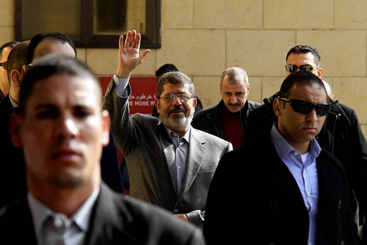 Egyptian President Mohamed Morsi waves to supporters in Cairo after a prayer service this month.