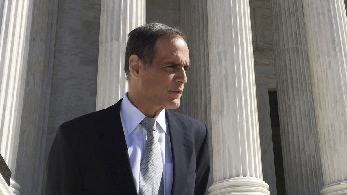Florida resident Fane Lozman stands on the steps of the Supreme Court in Washington, after oral arguments in his case.