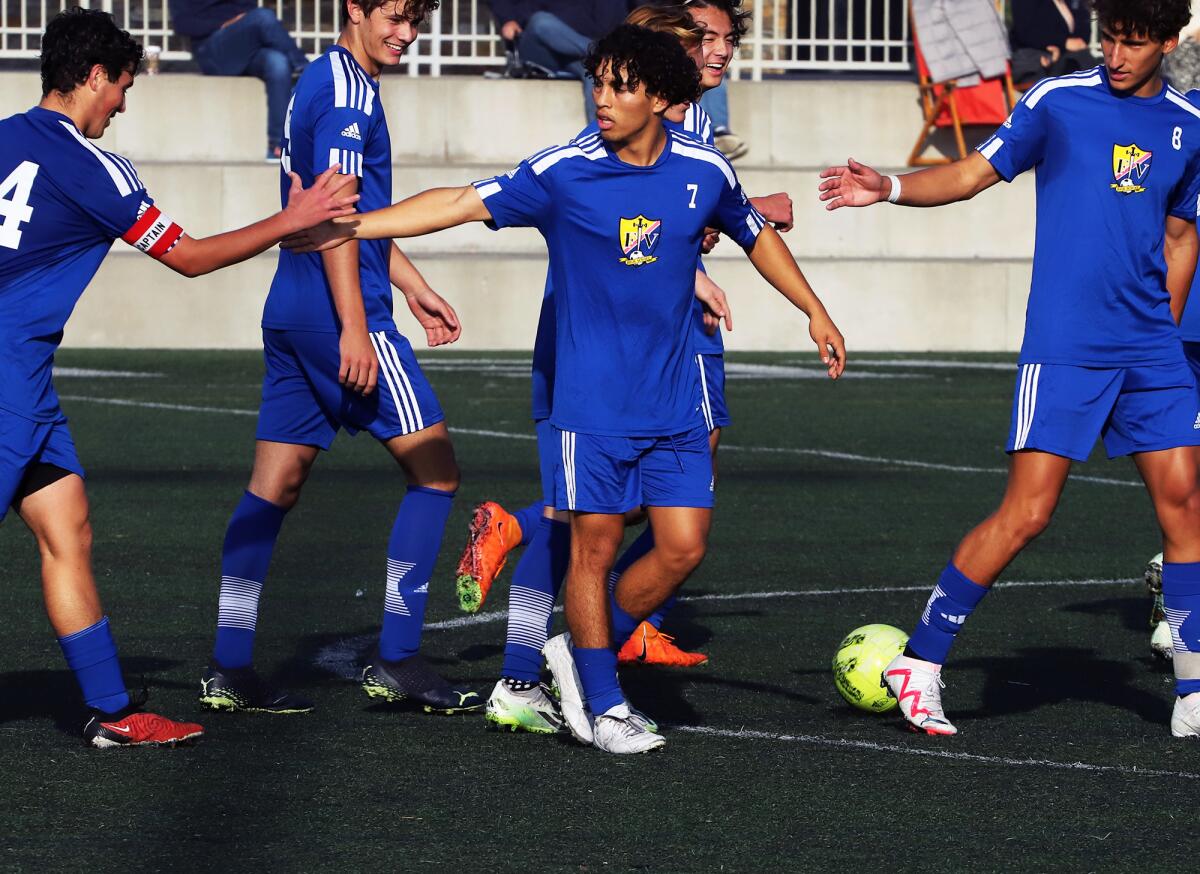 Fountain Valley's Jacob Cortez (7) celebrates with his team after scoring a goal against Sage Hill.