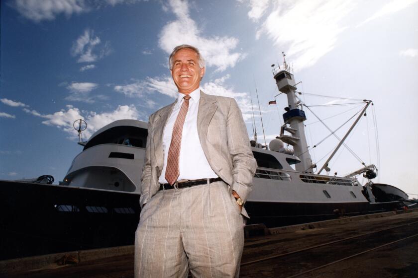 August Felando with tuna boats in the background. Felando retired in 1991 after 31 years as president of the American Tunaboat Association .(Photo by:Nelvin C. Cepeda / The San Diego Union-Tribune)