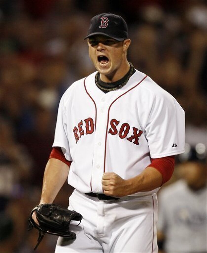 Boston Red Sox starting pitcher Jon Lester pumps his fist after striking out Tampa Bay Rays' Rocco Baldelli with two men on base to end the sixth inning of a baseball game at Fenway Park in Boston, Monday, Sept. 8, 2008. (AP Photo/Winslow Townson)