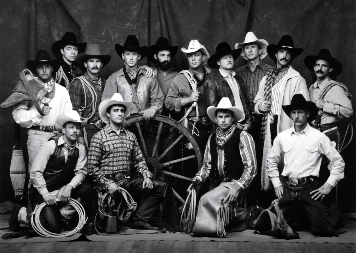 A group of cowboys posed together.