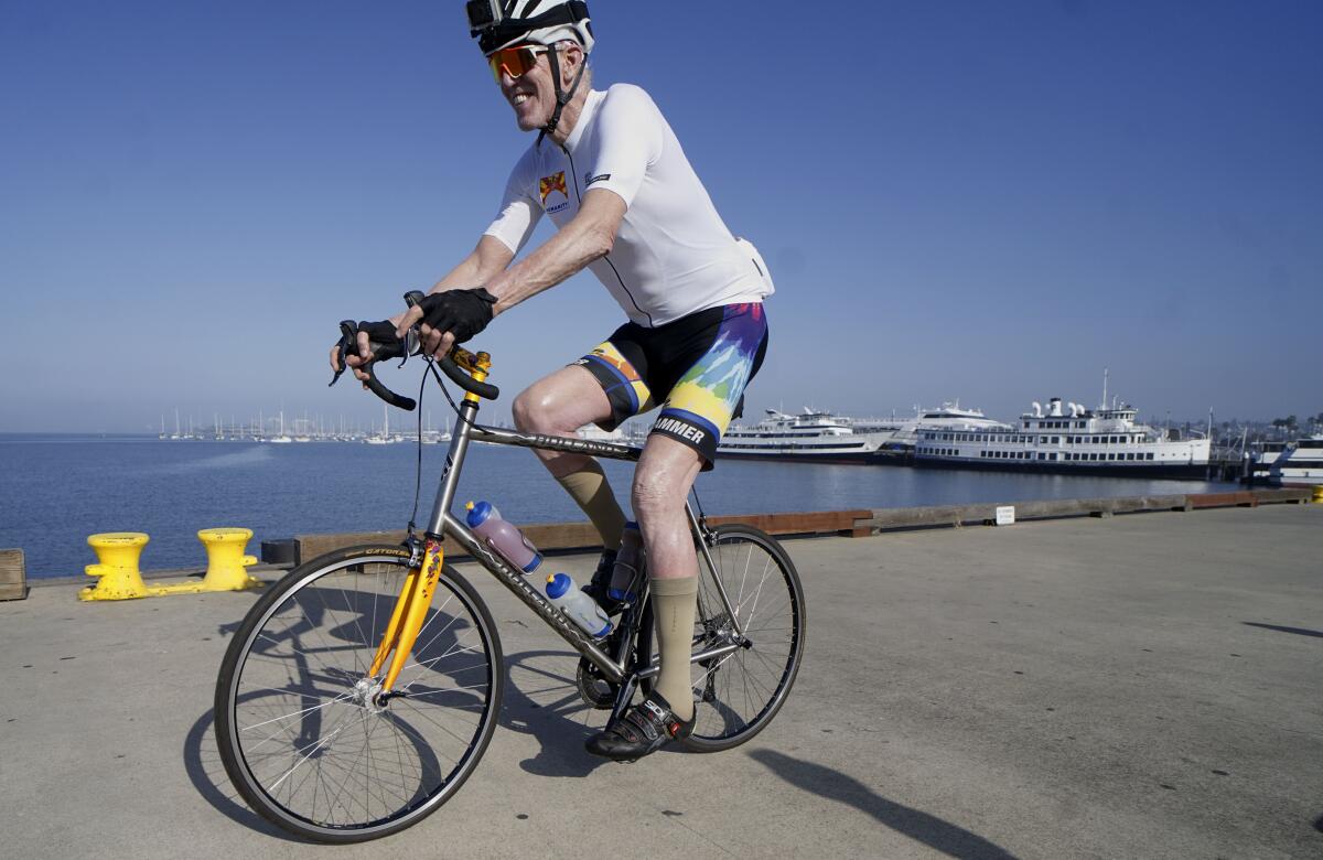 Former NBA star Bill Walton rides his bike along Harbor Drive during the for Bike for Humanity on April 25, 2020.