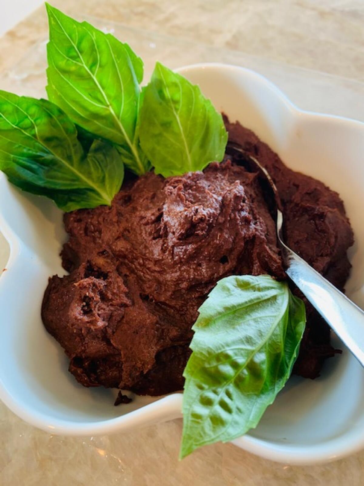 Tipsy Acorn Chocolate Mousse garnished with fresh basil leaves
