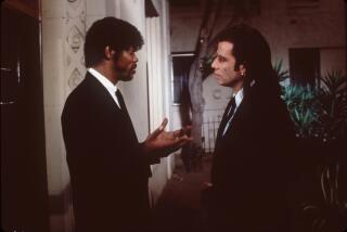 Two men in black suits talking to each other