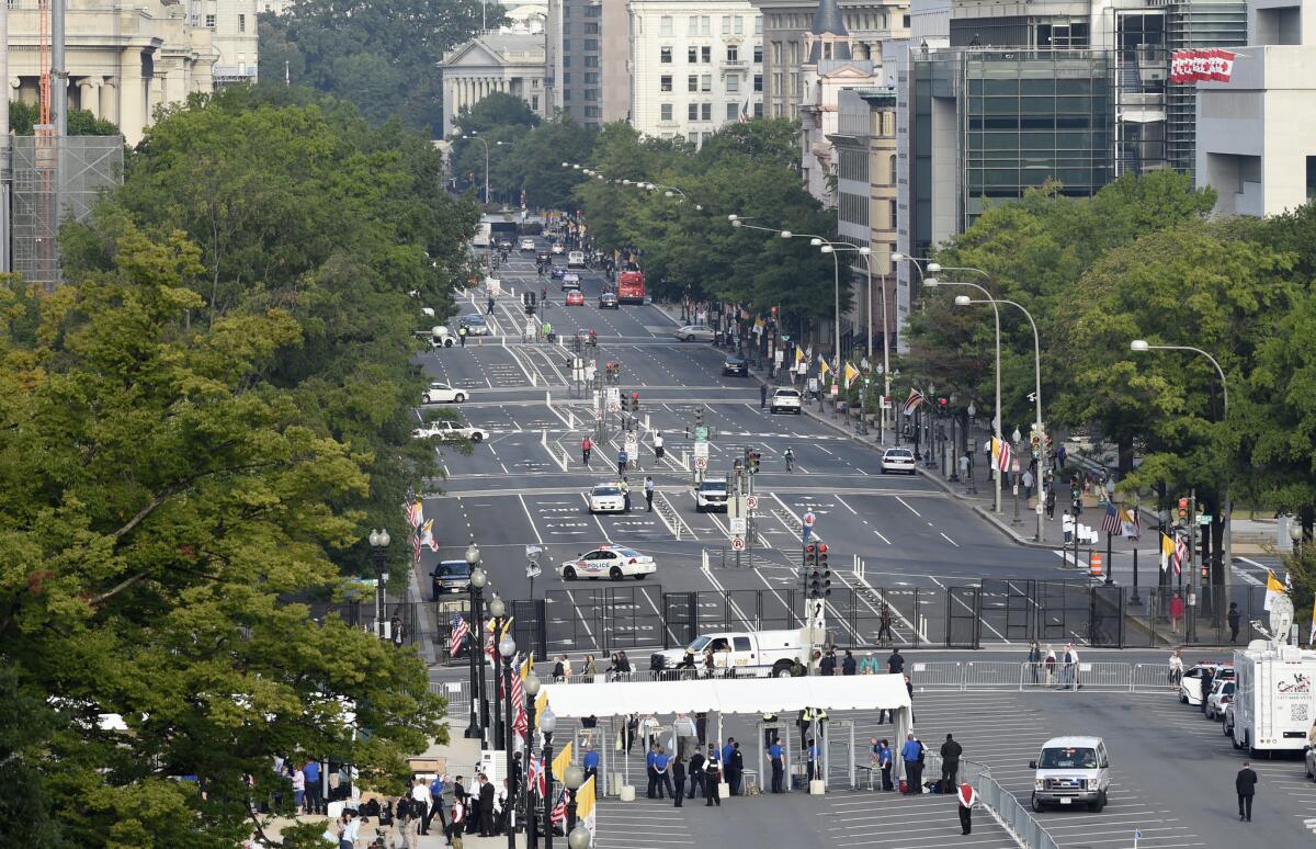 Pennsylvania Avenue in Washington is closed to vehicles, Thursday, Sept. 24, 2015, as people walk to get through security to see Pope Francis appear from the Speaker's Balcony on Capitol Hill. The Pope will addresses a joint meeting of Congress making him the first pontiff in history to do so. (AP Photo/Susan Walsh)