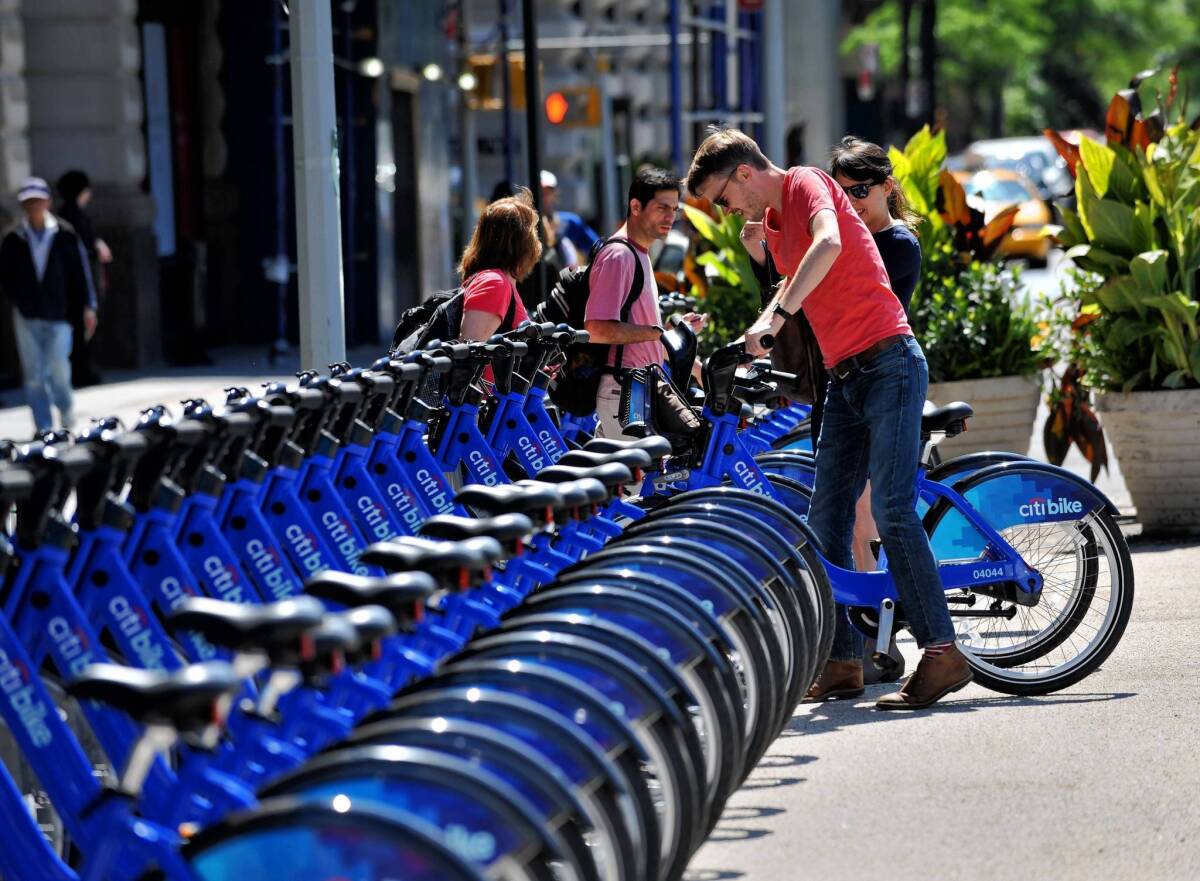 A couple pick out bicycles to rent from the CitiBike bike sharing program in New York. Citibank is a sponsor of the program, which launched last month.
