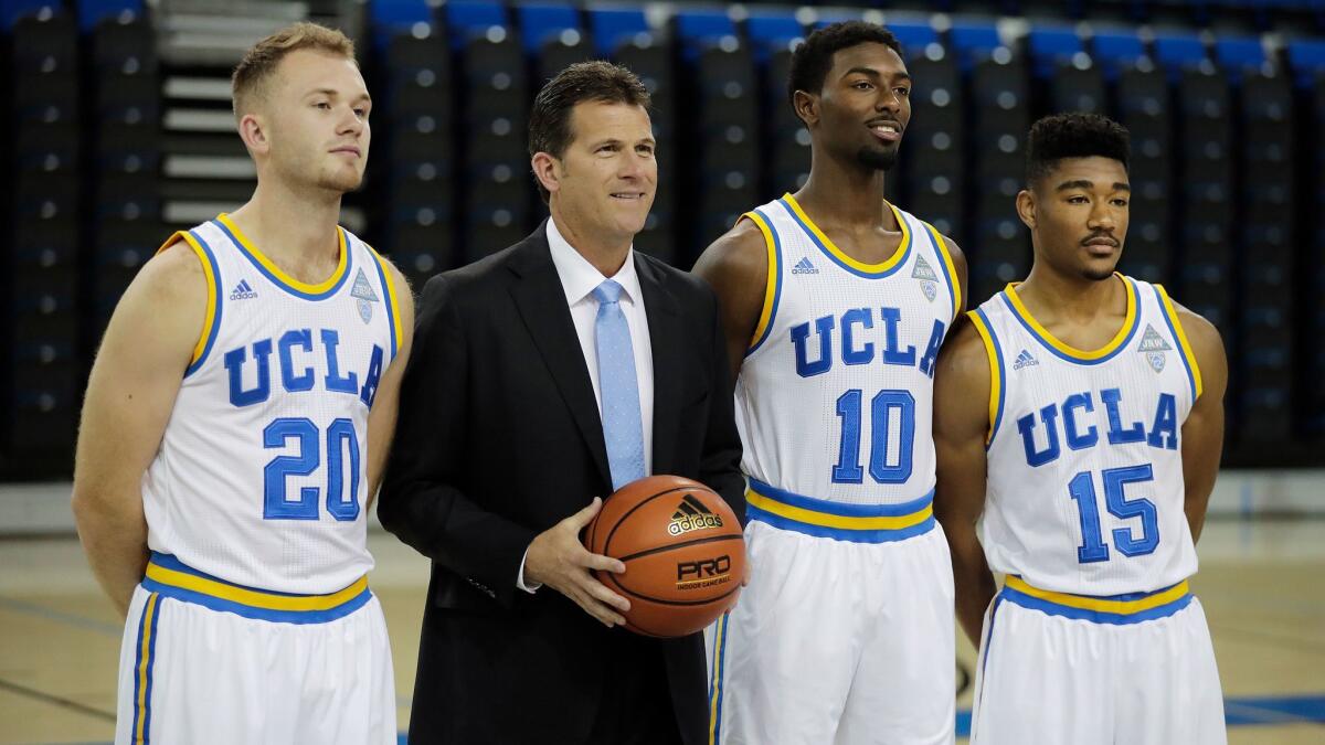 UCLA players Bryce Alford, left, Isaac Hamilton and Jerrold Smith pose with Coach Steve Alford on Oct. 12.